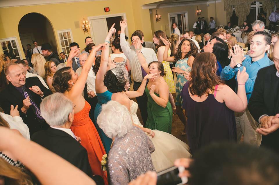 Guests dancing with the bride at a wedding reception
